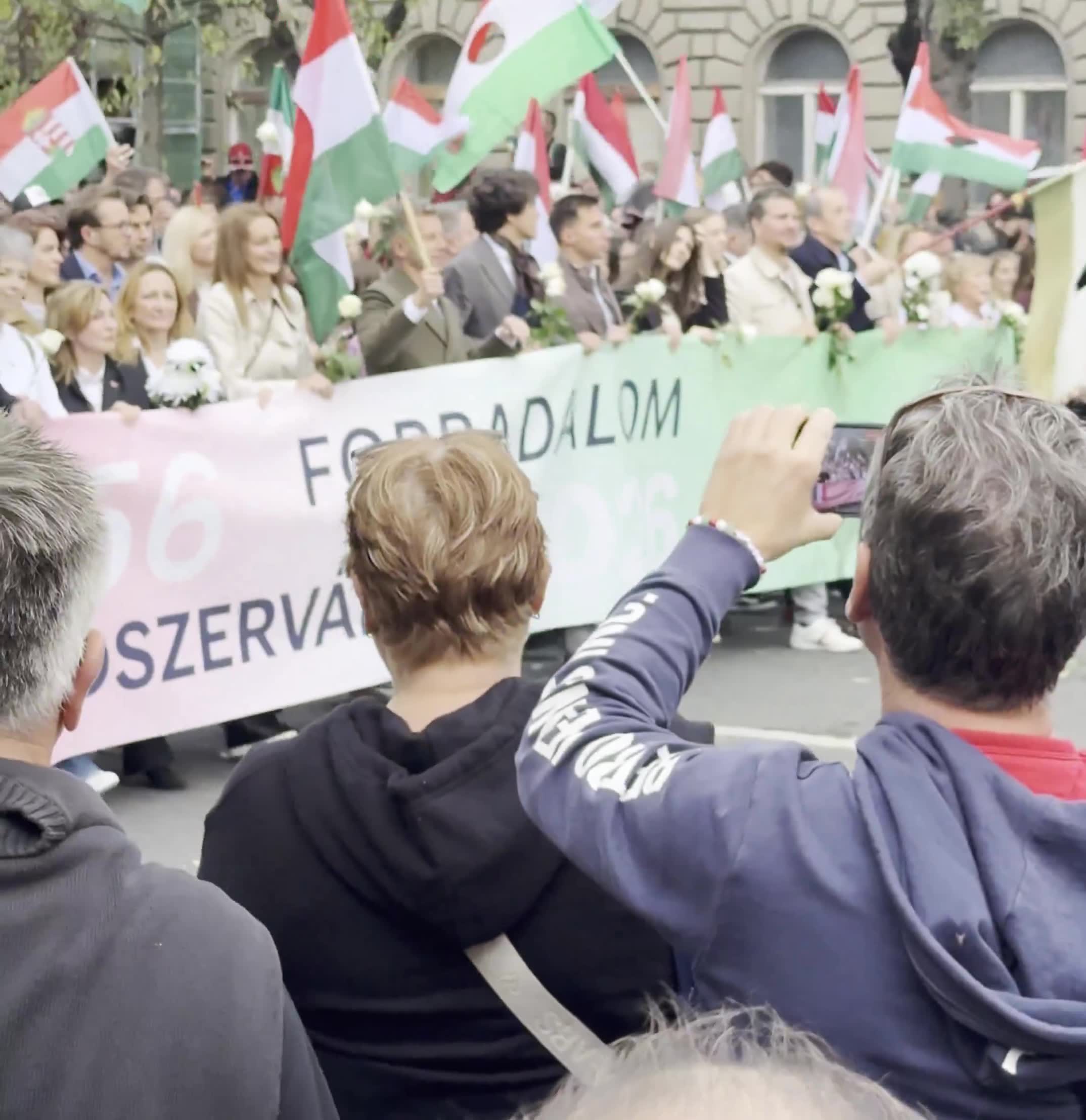 Budapest marks the anniversary of the 1956 anti-Soviet revolution with two major rallies. Orbán’s “peace march,” led by a banner reading “We won’t die for Ukraine,” has ended — now opposition leader Péter Magyar’s “national march” heads with supporters toward Heroes’ Square