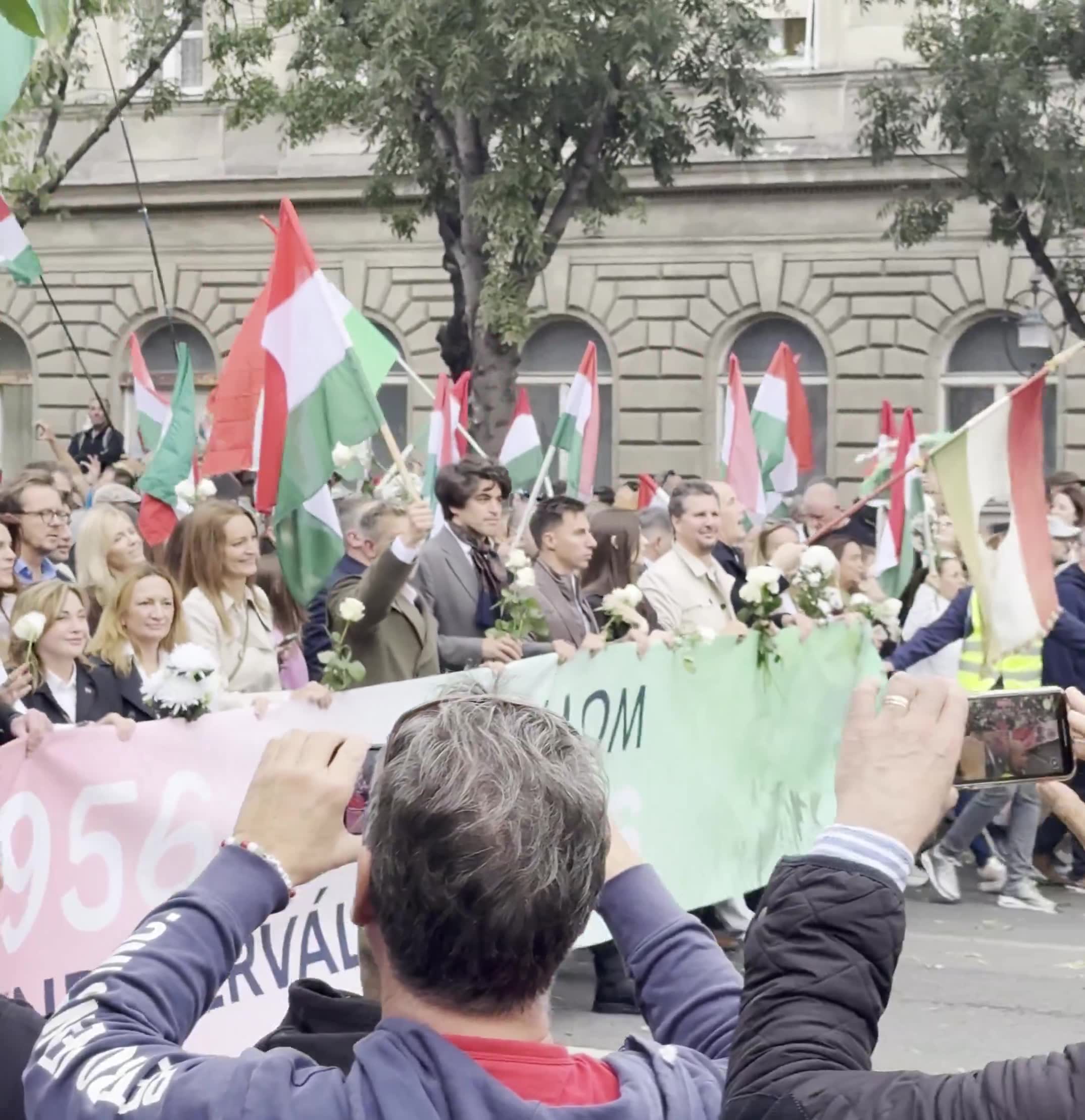Budapest marks the anniversary of the 1956 anti-Soviet revolution with two major rallies. Orbán’s “peace march,” led by a banner reading “We won’t die for Ukraine,” has ended — now opposition leader Péter Magyar’s “national march” heads with supporters toward Heroes’ Square