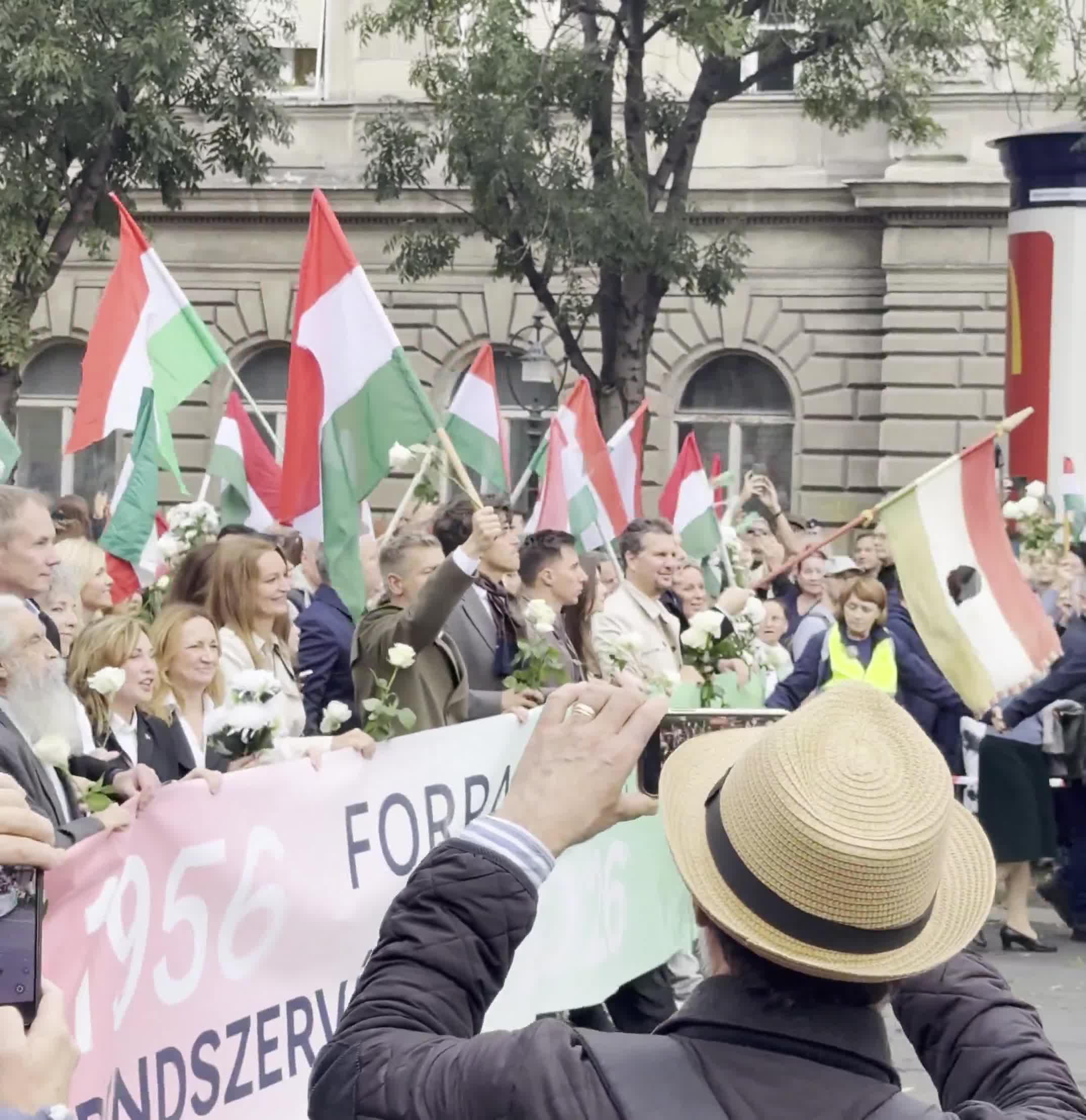 Budapest marks the anniversary of the 1956 anti-Soviet revolution with two major rallies. Orbán’s “peace march,” led by a banner reading “We won’t die for Ukraine,” has ended — now opposition leader Péter Magyar’s “national march” heads with supporters toward Heroes’ Square