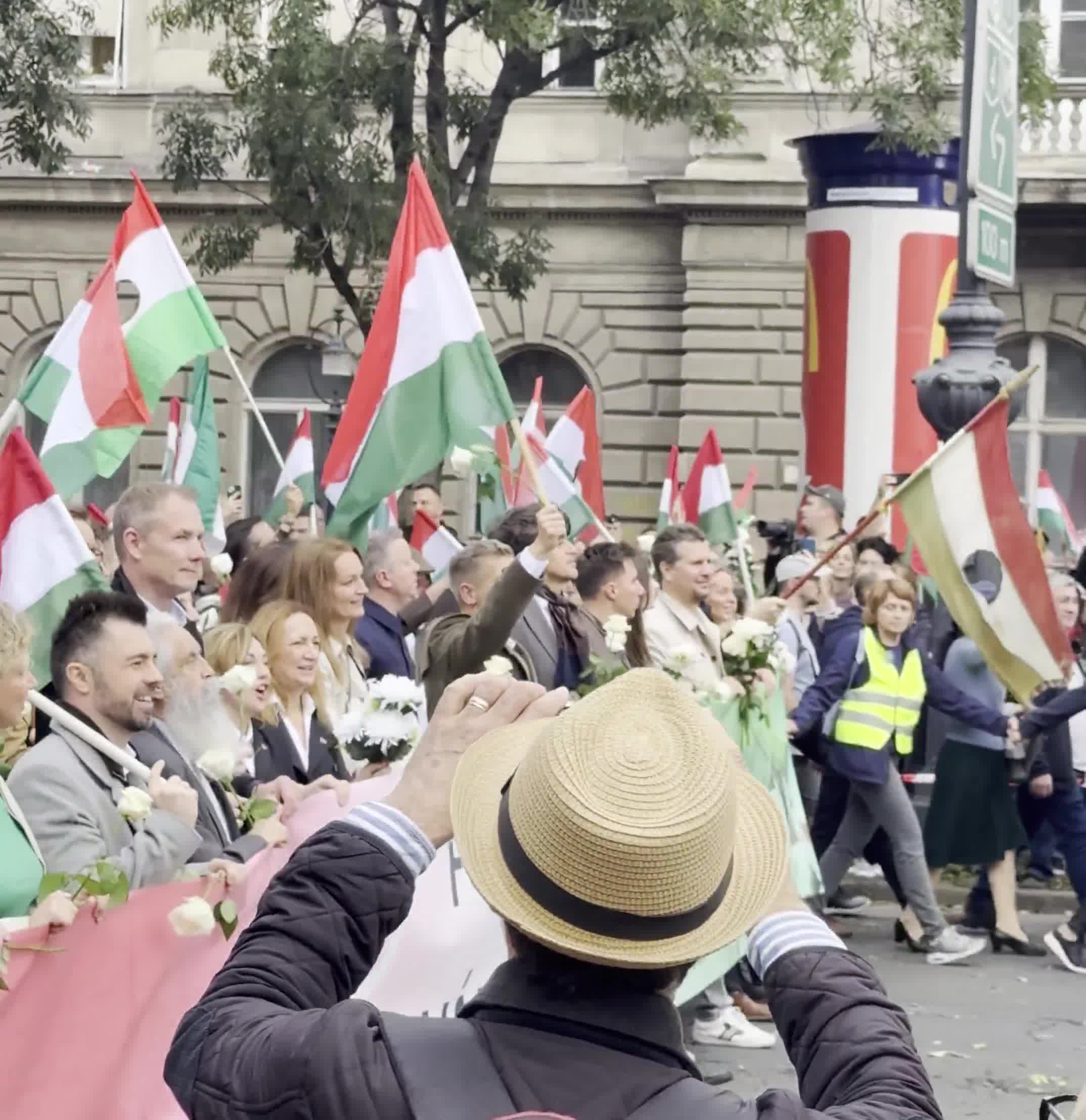 Budapest marks the anniversary of the 1956 anti-Soviet revolution with two major rallies. Orbán’s “peace march,” led by a banner reading “We won’t die for Ukraine,” has ended — now opposition leader Péter Magyar’s “national march” heads with supporters toward Heroes’ Square