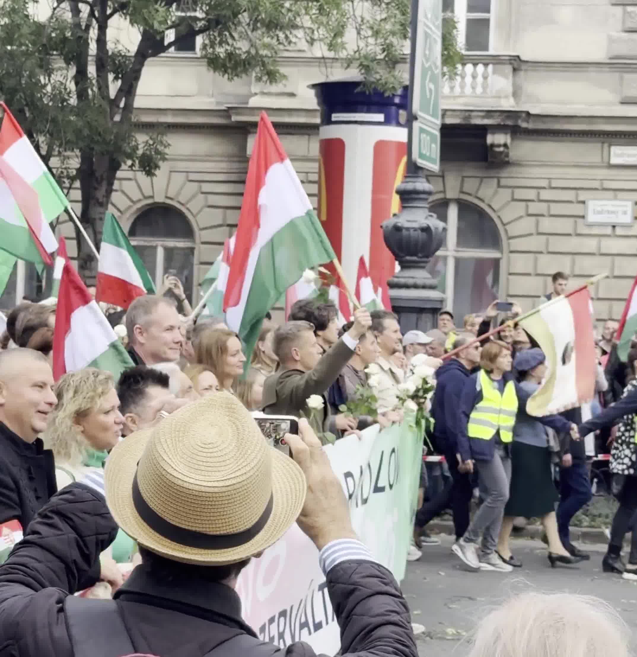 Budapest marks the anniversary of the 1956 anti-Soviet revolution with two major rallies. Orbán’s “peace march,” led by a banner reading “We won’t die for Ukraine,” has ended — now opposition leader Péter Magyar’s “national march” heads with supporters toward Heroes’ Square